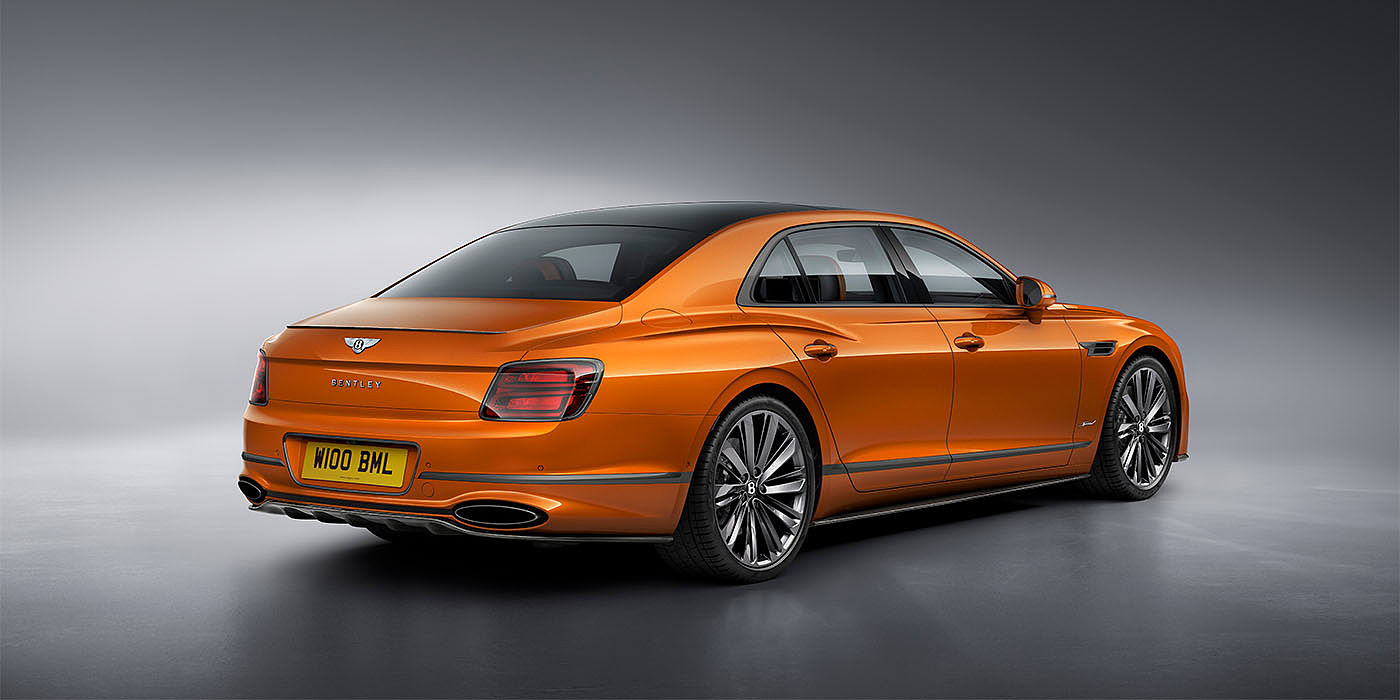 Bentley Beirut Bentley Flying Spur Speed in Orange Flame colour rear view, featuring Bentley insignia and enhanced exhaust muffler.