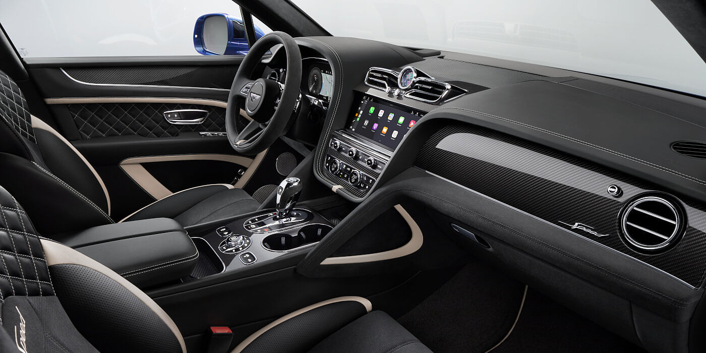 Bentley Beirut Bentley Bentayga Speed SUV front interior in Beluga black and Linen hide with carbon fibre veneer