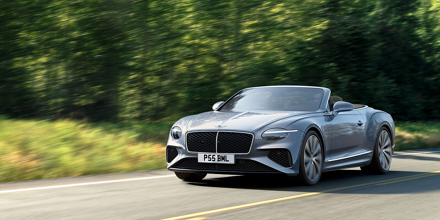 Bentley Beirut New Bentley Continental GTC convertible front view in Silverlake paint with 22 inch ten spoke wheels, driving dynamically on a country road