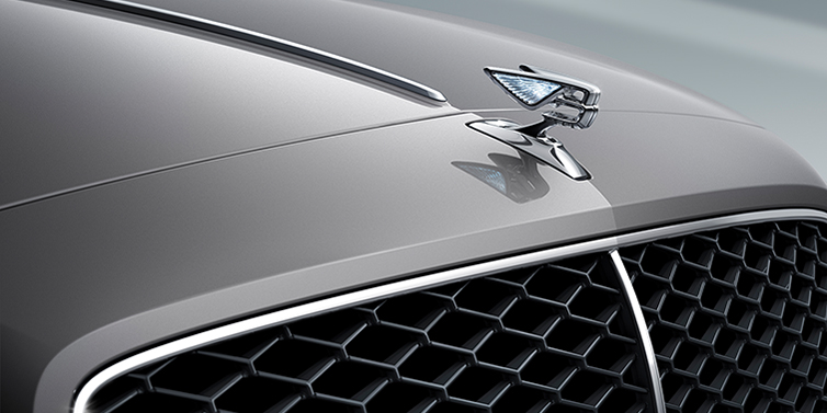 Bentley Beirut New Bentley Flying Spur sedan bonnet detail in Silverlake paint with Illuminated Flying B bonnet badge and matrix grille with chrome surround